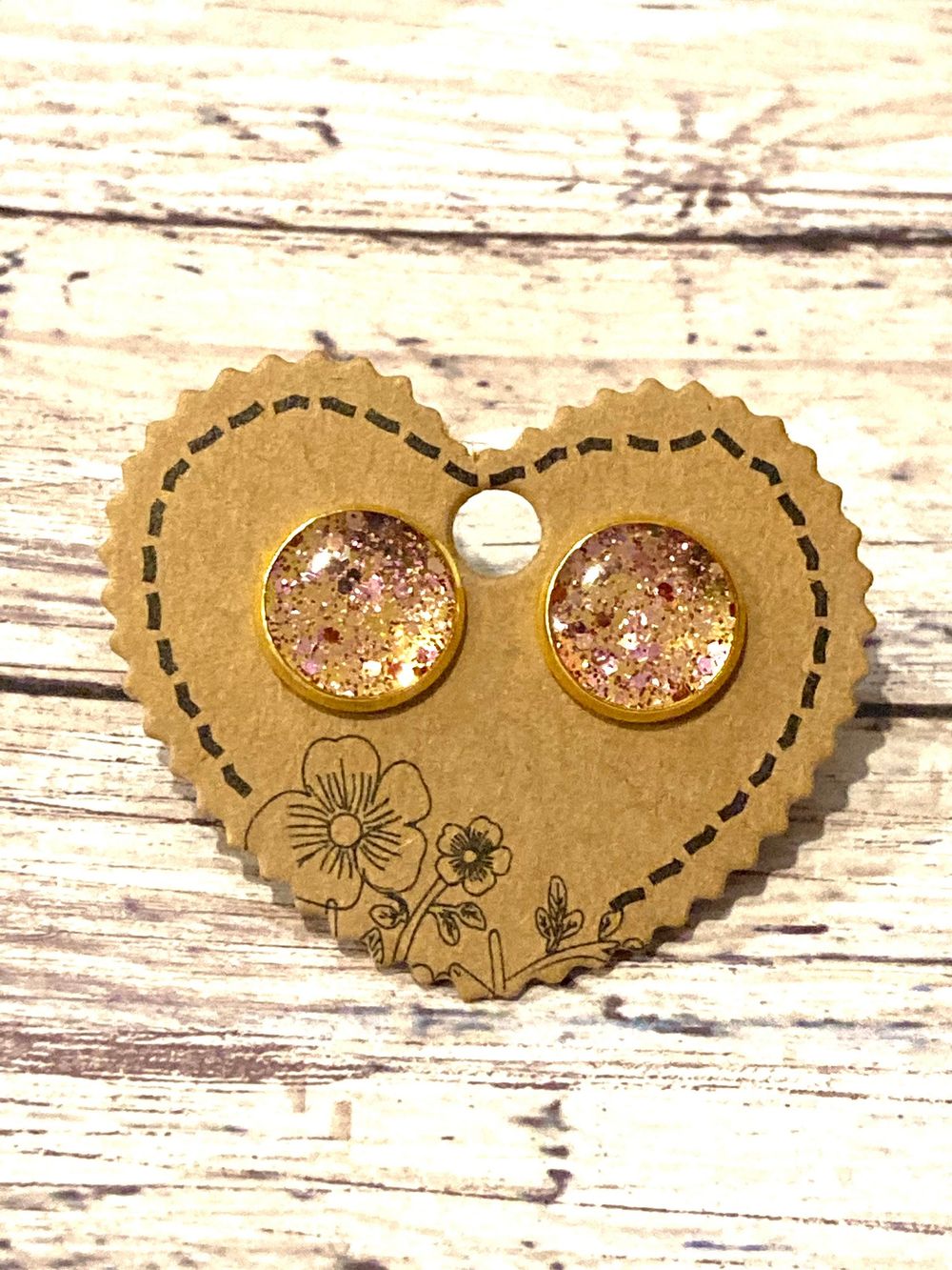 Gold stud earrings with pink sparkle resin